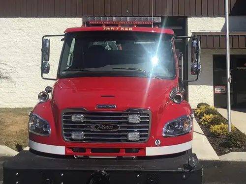 Head-on front view showing grille, hood-mounted lights, windshield, and bumper-mounted warning lights.