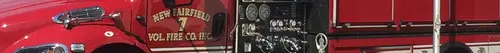 Panoramic side crop showing cab door area and pump panel section.