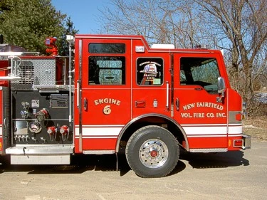 Driver-side cab close-up showing open pump panel area and controls