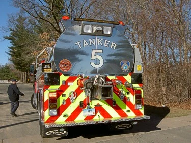 Direct rear view showing red-yellow chevrons and rear discharge connections