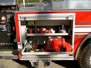 Open side compartment showing intake fittings and portable pump equipment