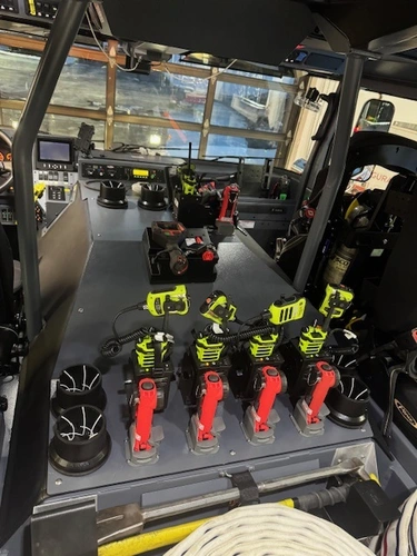 Cab interior view showing control console, dashboard, and mounted equipment