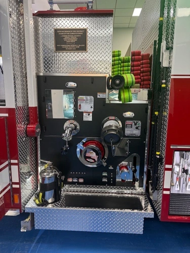 Pump panel close-up showing gauges, valves, and hose connections