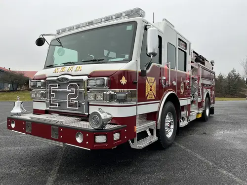 Front-right exterior close view showing grille, bumper, and warning lights