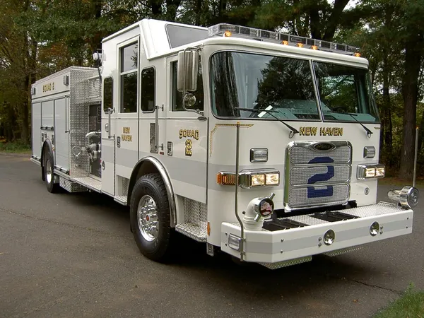 Rescue squad truck front-left exterior view showing enclosed cab and long body
