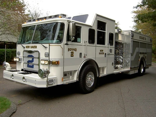 Front-left exterior view showing bumper, cab, and long body