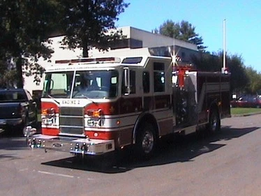 Front-left exterior angle showing grille, bumper, cab doors, and side compartment body.