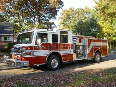 Pumper front-left exterior view showing enclosed cab and side compartments