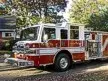 Pumper front-left exterior view showing enclosed cab and side compartments