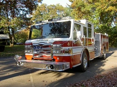 Front-left exterior view showing cab, bumper, and side body