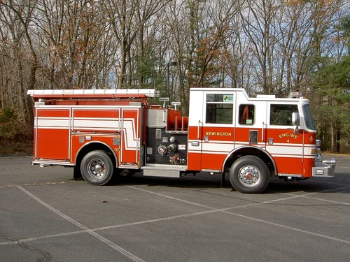 Full right-side profile showing pump panel position, side compartments, and wheel/tire layout.