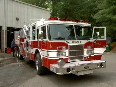 Front right close view showing chrome bumper, grille, windshield lights, and cab door area.