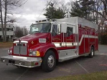 Front right exterior view of a tactical support truck with commercial cab, chrome bumper, and box body compartments.