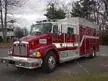 Wide front right view of the parked tactical unit showing bumper, cab, and box body.