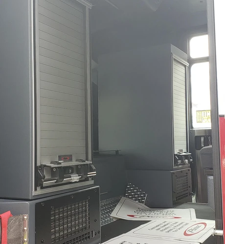 Open side compartment showing empty shelf bay and interior paneling