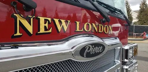 Front grille close-up showing raised department script and Pierce badge