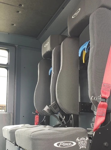 Cab interior side view showing rear seat and seatbelt mounts