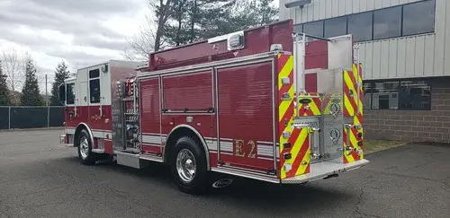 Rear-left exterior view showing side body and rear chevron striping