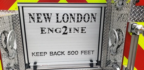 Rear chevron close-up showing warning sign panel and unit identification