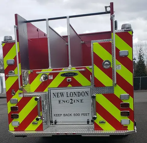 Rear view showing chevrons, rear lights, and hosebed area