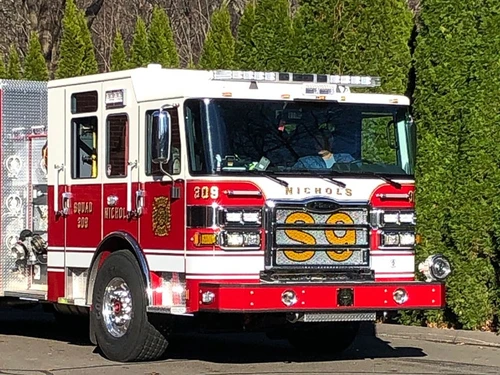 Pumper front-left exterior view showing bumper, cab, and side compartments