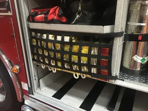 Open side compartment showing mounted equipment bag and storage tray