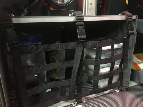 Open compartment close-up showing secured equipment bag and strap mounts
