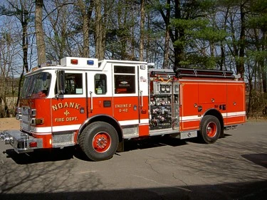 Driver-side profile showing pumper body, pump panel, and wheel layout