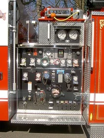 Pump panel close-up showing gauges, valves, and control levers