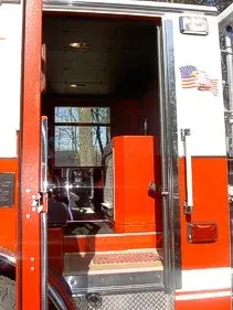 Crew-cab side door open view showing rear seat area and interior step