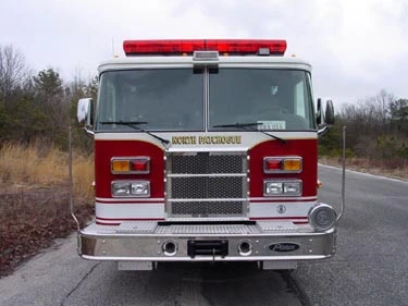 Front exterior view showing grille, bumper, and warning lights