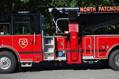 Mid-body side close-up showing the turntable area, side compartments, and outrigger assembly.