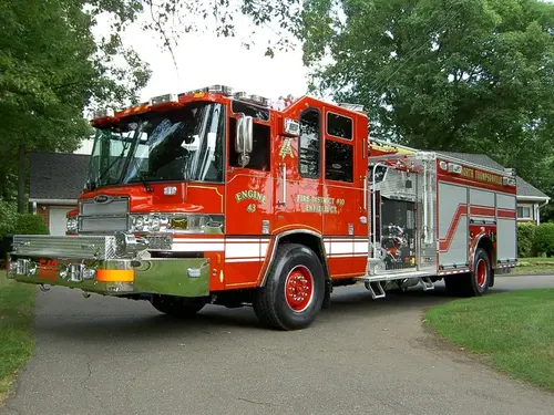 Front-left exterior view showing bumper, cab, and side compartments