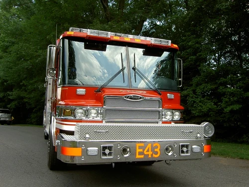 Front exterior view showing grille, bumper, and warning lights