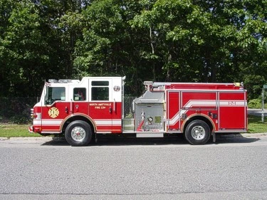 Driver-side full profile showing the midship pump panel, side compartments, and rear wheel area.