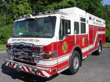 Rescue pumper front-left exterior view showing enclosed cab and side compartments