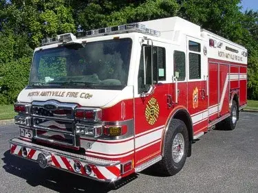 Rescue pumper front-left exterior view showing enclosed cab and side compartments
