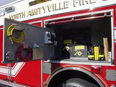Open side compartment showing hand tools, hose fittings, and storage shelf