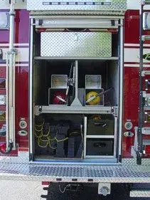 Open rear compartment view showing shelves, bags, and small equipment