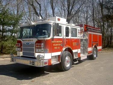 Pumper front-left exterior view showing enclosed cab and side compartments