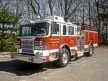 Pumper front-left exterior view showing enclosed cab and side compartments