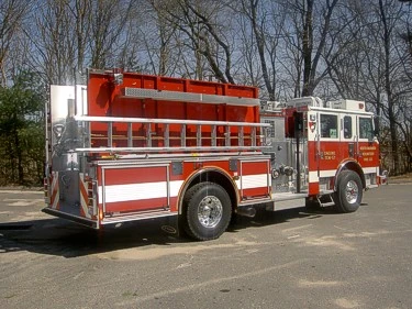 Rear-right exterior view showing side hosebed rails and rear body panel