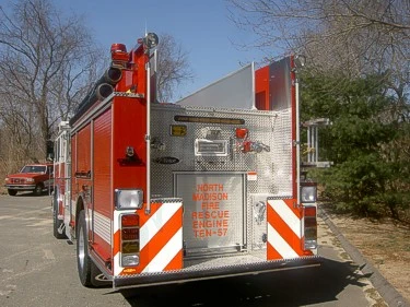Rear view showing chevrons, rear door panel, and warning lights