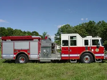 Full right-side profile showing side compartments, midship pump controls, and wheel/tire layout.