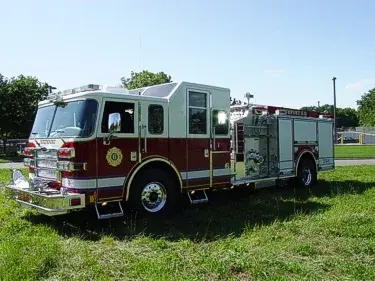Front right angle showing cab doors, pump panel section, and rear body compartments.