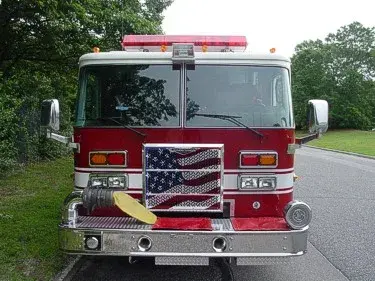 Head-on front view showing grille, windshield, warning lights, and front intake ports.