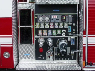 Close-up of the midship pump panel with gauges, intake controls, valves, and switch labels.