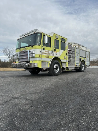 Front-right exterior view showing cab profile and side pump panel section