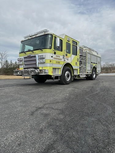 Front-right exterior view highlighting bumper, front wheel, and side body