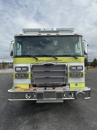 Head-on front view showing grille, bumper-mounted speakers, and warning lights